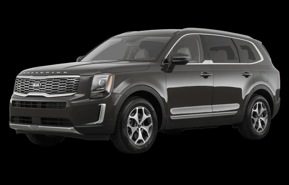 Dark Kia SUV parked outside a modern building